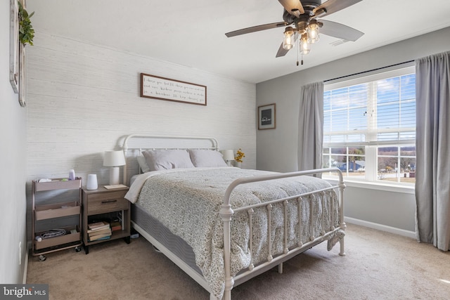 bedroom featuring light carpet, visible vents, a ceiling fan, and baseboards