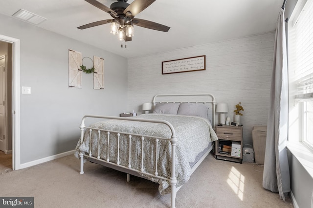 bedroom featuring visible vents, a ceiling fan, baseboards, and carpet floors