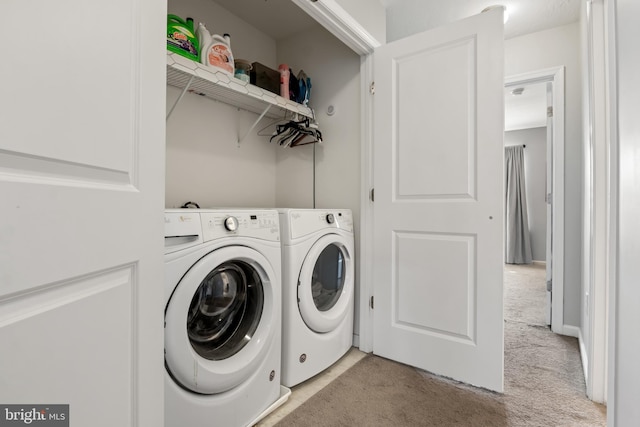 washroom featuring laundry area, separate washer and dryer, and light carpet