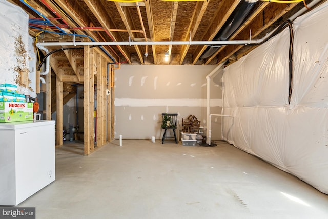 unfinished basement with washer / dryer