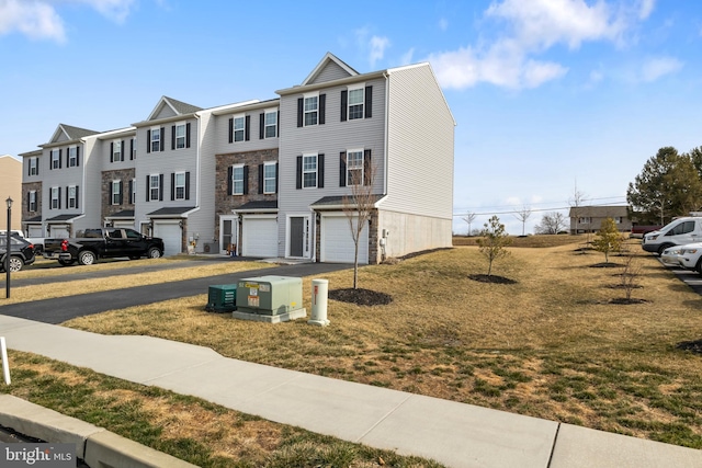 multi unit property with a garage, a residential view, and driveway