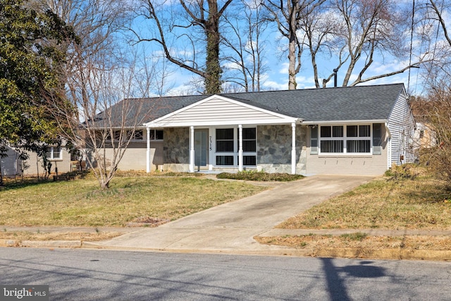 single story home featuring a front yard, brick siding, stone siding, and roof with shingles