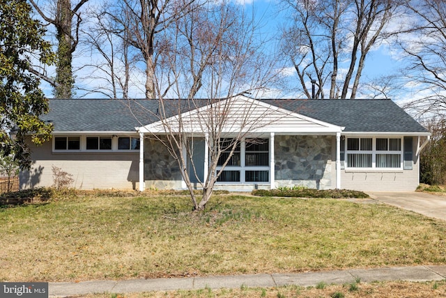 single story home with brick siding, roof with shingles, and a front yard