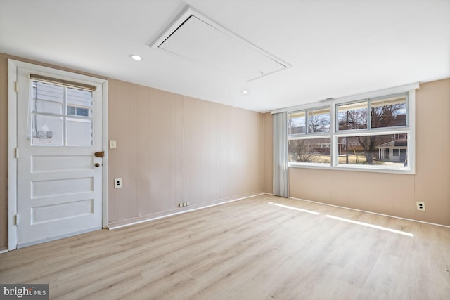 unfurnished room featuring recessed lighting, attic access, and wood finished floors