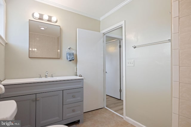 bathroom with tile patterned floors, toilet, vanity, and crown molding