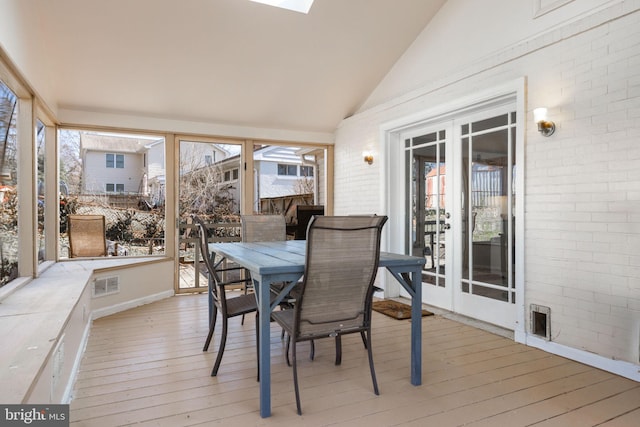 sunroom with visible vents, french doors, and vaulted ceiling