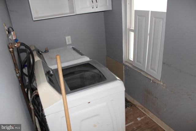 laundry area with washer / dryer and dark wood-style floors