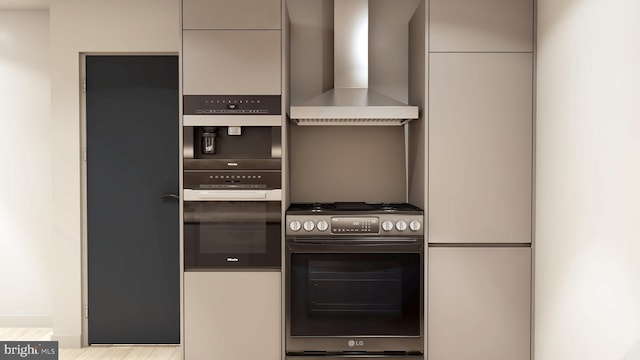 kitchen featuring wall chimney exhaust hood, fridge, and light hardwood / wood-style floors