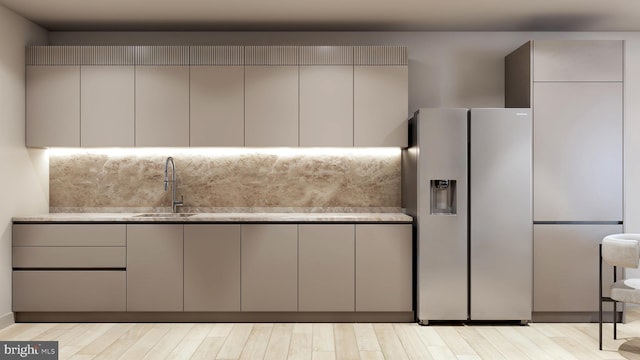 kitchen featuring gray cabinets, light hardwood / wood-style floors, sink, and stainless steel refrigerator with ice dispenser