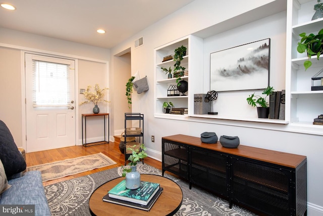 entryway with hardwood / wood-style floors