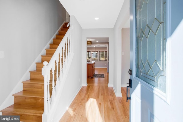 entryway featuring light wood-style floors, recessed lighting, stairway, and baseboards