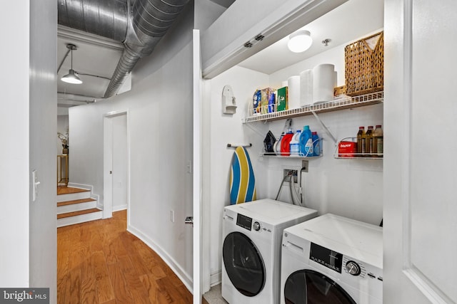 washroom with light wood-style floors, washer and dryer, laundry area, and baseboards