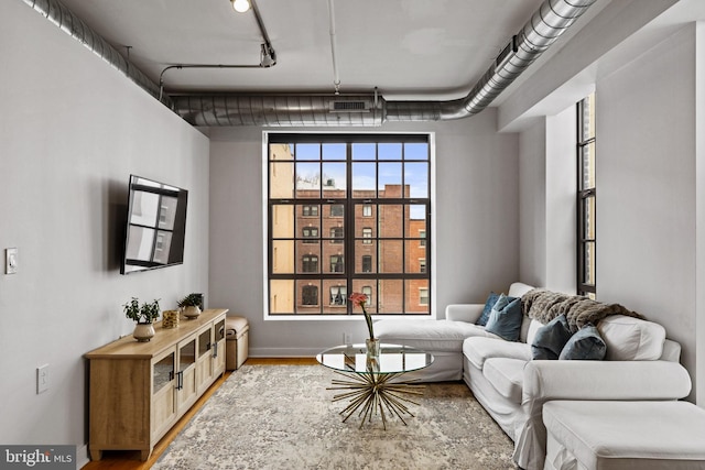 sitting room with visible vents and wood finished floors