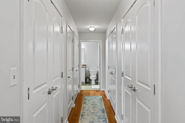 corridor with dark wood-style flooring