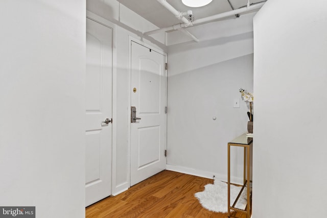 interior space featuring baseboards and wood finished floors