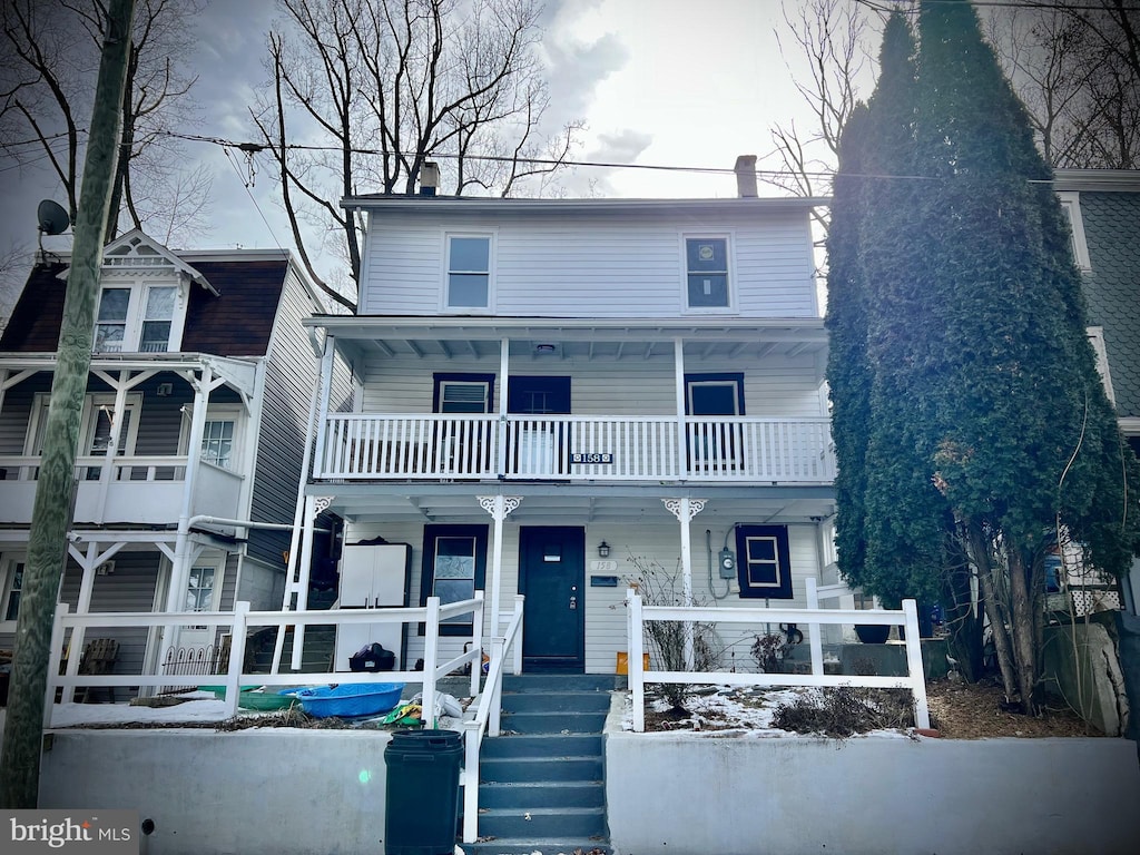 view of front of house featuring a balcony and a porch