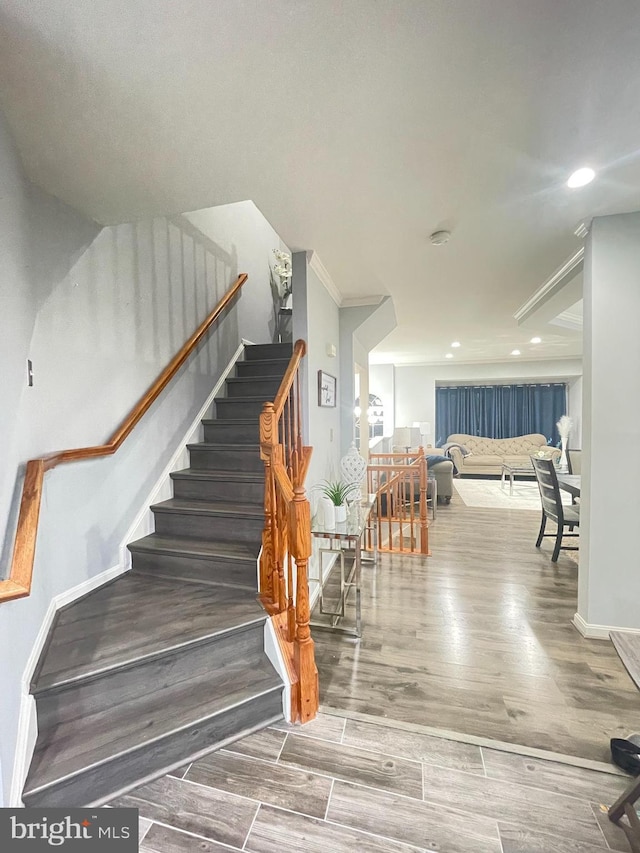 stairs with recessed lighting, baseboards, and wood finished floors