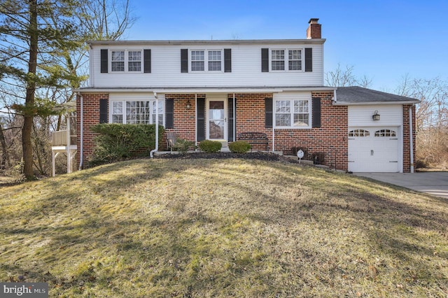 view of front of house featuring a garage and a front lawn