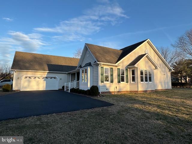 view of home's exterior featuring a garage and a yard