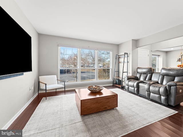 living room with dark wood-style floors and baseboards