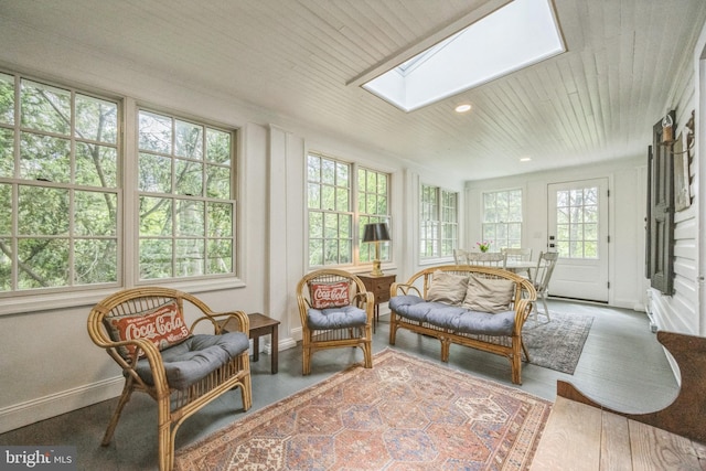 sunroom with french doors, a skylight, recessed lighting, wooden ceiling, and baseboards