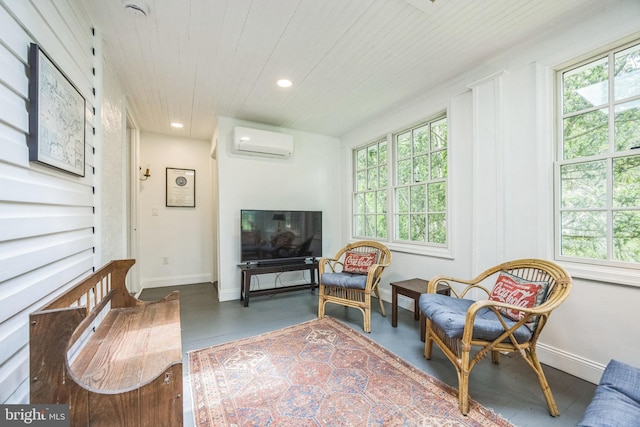 sitting room featuring an AC wall unit, healthy amount of natural light, wooden ceiling, recessed lighting, and finished concrete flooring