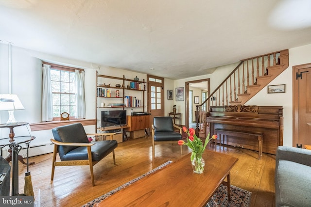 living area with wood-type flooring and stairway