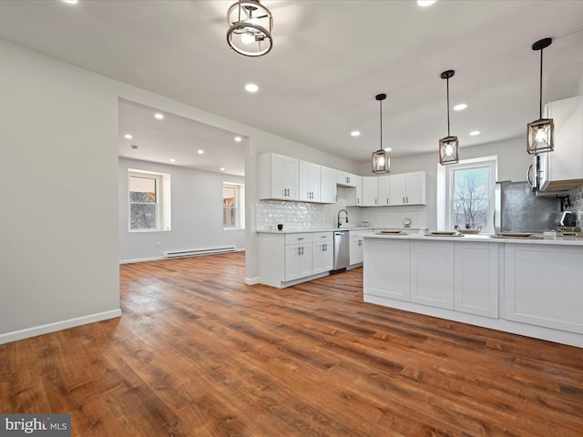 kitchen featuring wood-type flooring, white cabinetry, dishwasher, decorative light fixtures, and decorative backsplash