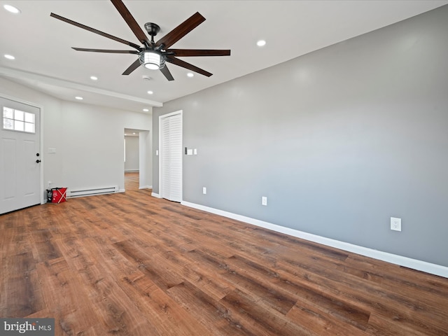 interior space featuring a baseboard radiator, ceiling fan, and wood-type flooring