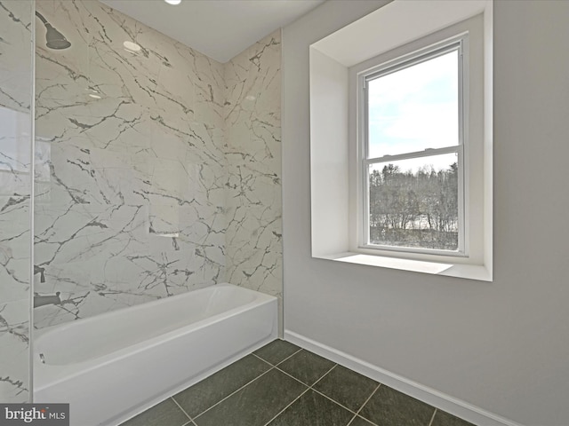 bathroom featuring tiled shower / bath combo and tile patterned flooring