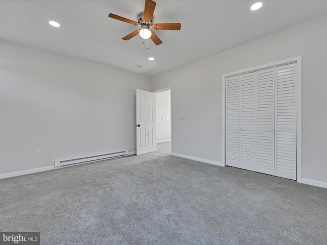 unfurnished bedroom featuring carpet, a closet, ceiling fan, and baseboard heating