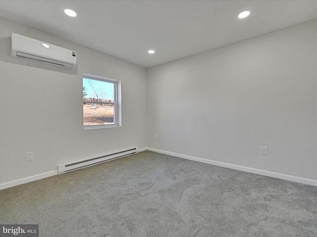 spare room featuring a baseboard heating unit, a wall unit AC, and light colored carpet