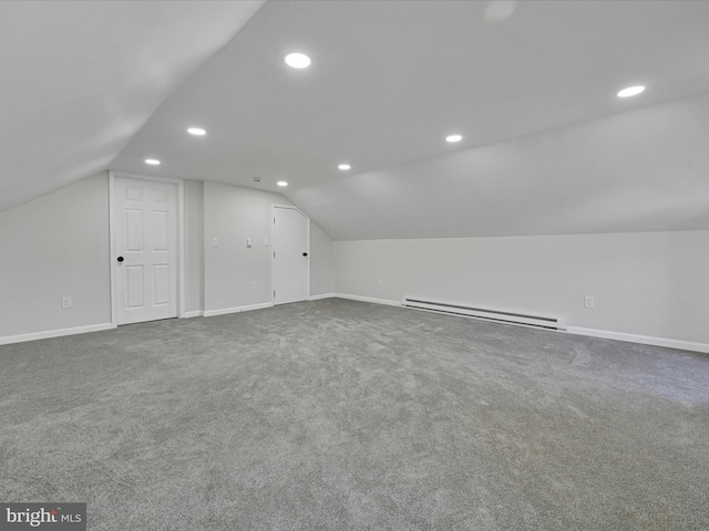 bonus room featuring a baseboard heating unit, lofted ceiling, and carpet flooring