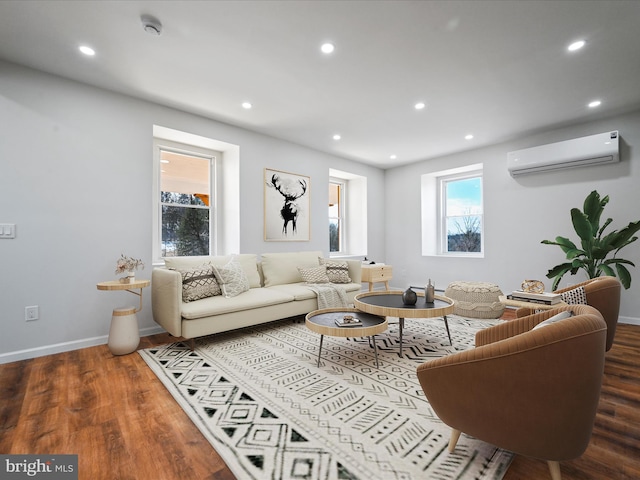 living room with an AC wall unit and dark wood-type flooring