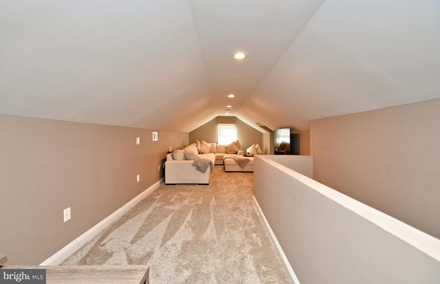 interior space with lofted ceiling, light carpet, baseboards, and recessed lighting