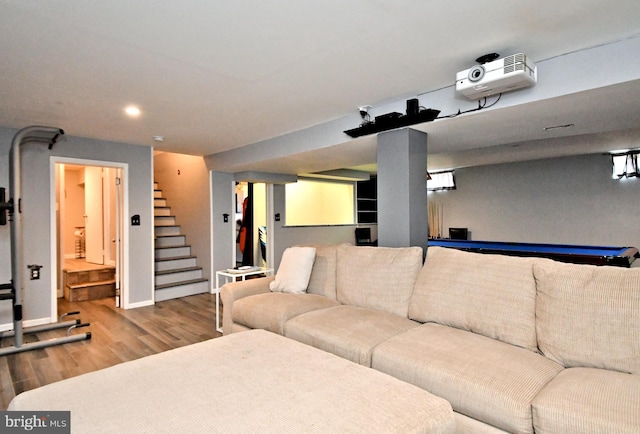 living room featuring stairs, recessed lighting, baseboards, and wood finished floors