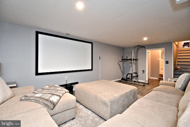 home theater room with baseboards, wood finished floors, and recessed lighting