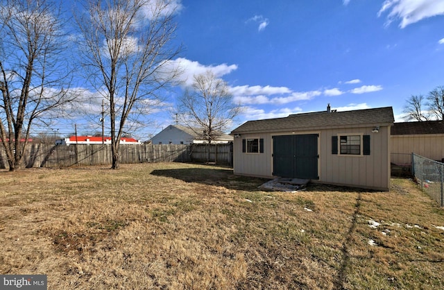 exterior space with an outbuilding and a fenced backyard