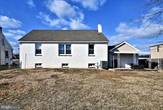 rear view of property with a chimney, a shingled roof, a patio area, fence, and cooling unit