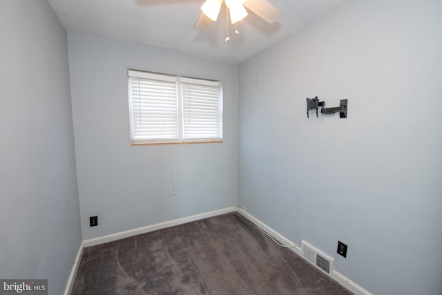 unfurnished room with dark colored carpet, visible vents, ceiling fan, and baseboards