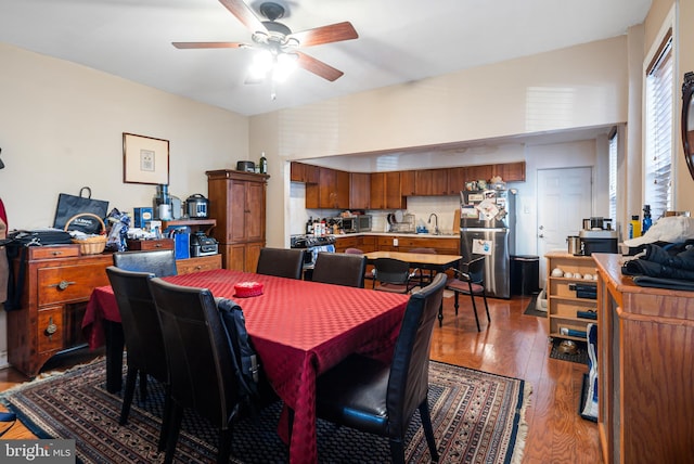 dining area with sink, hardwood / wood-style floors, and ceiling fan