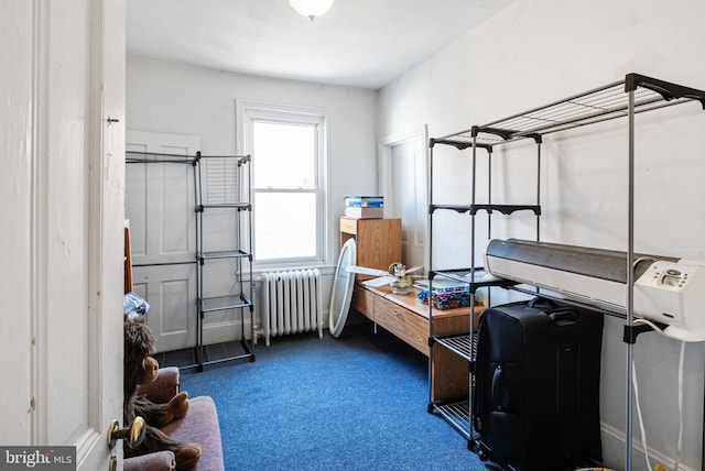 interior space with dark colored carpet and radiator heating unit