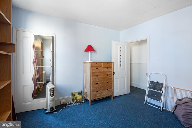 miscellaneous room featuring dark carpet