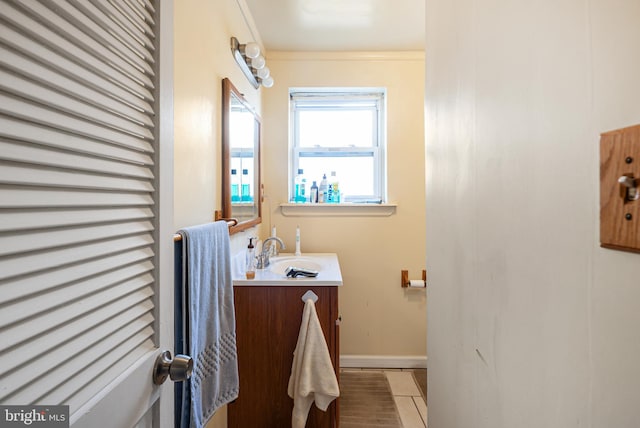 bathroom with tile patterned flooring, vanity, and ornamental molding