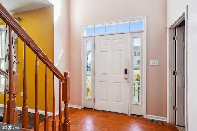 entrance foyer featuring a wealth of natural light and hardwood / wood-style flooring