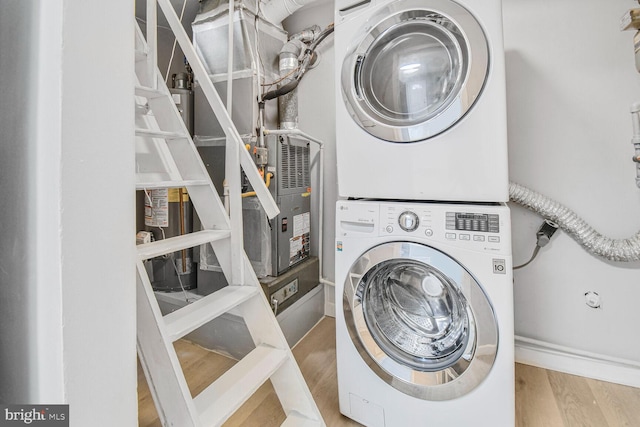 2715 Terrapin Rd, Silver Spring, MD 20906 - laundry room with baseboards, stacked washer and dryer, wood finished floors, and laundry area