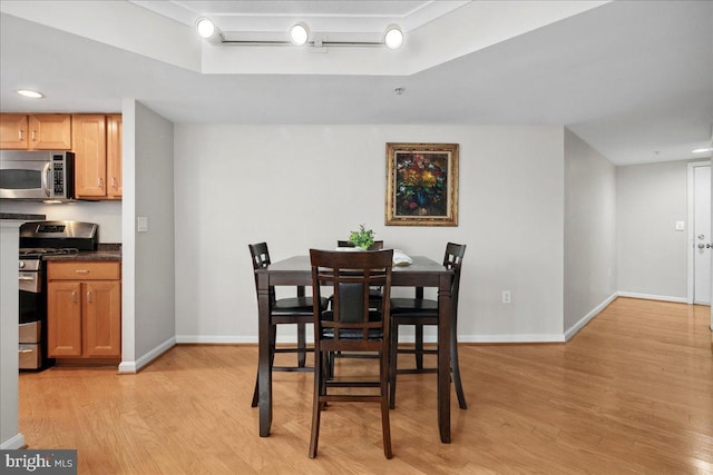 dining room with light wood-style flooring and baseboards