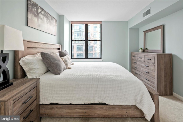 bedroom featuring light carpet and visible vents