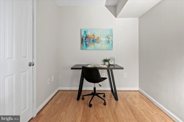 office area with wood finished floors and baseboards