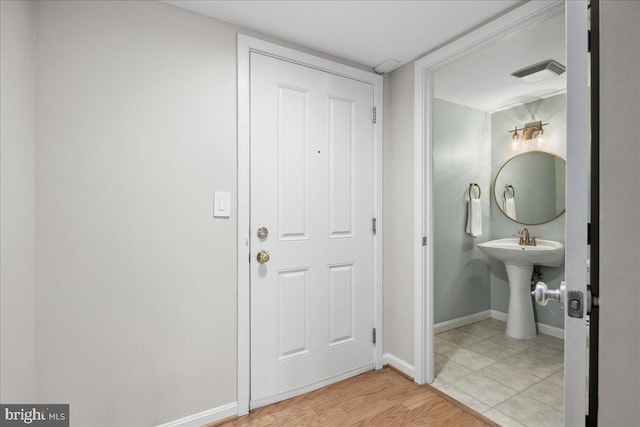 bathroom featuring wood finished floors, visible vents, and baseboards